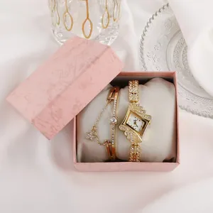 Women's gold diamond quartz watch and star bracelet set in pink gift box on white fabric