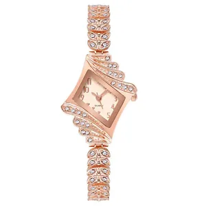 Macro detail of rose gold diamond-encrusted rhombic watch with wing-shaped metal strap