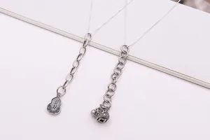 Macro detail of S925 sterling silver hollow gourd and lucky pouch pendant on a chain