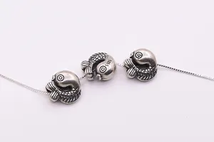 Detail of vintage S925 sterling silver koi fish beads with scale texture and S925 hallmark