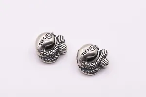 Macro shot of S925 sterling silver koi fish beads showing fish scale and fin textures
