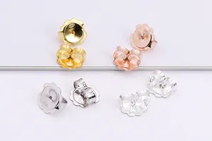 Macro detail of S925 sterling silver flower ear nuts in gold, rose gold and silver