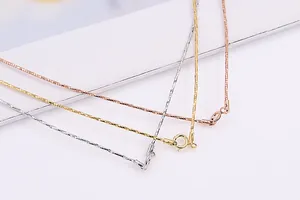 Detailed macro view of S925 silver necklaces in silver, gold, and rose gold finishes