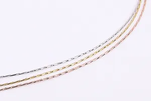 Macro shot of silver, gold, and rose gold sparkling S925 sterling silver fine necklaces