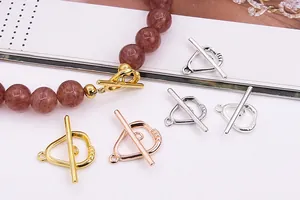 Macro shot of S925 sterling silver heart-shaped OT toggles in gold, rose gold and silver