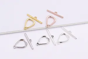 Macro detail of S925 sterling silver geometric OT clasps in gold and rose gold finishes