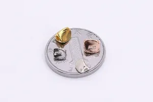 Detail of S925 sterling silver irregular spacer beads in four colors on a coin