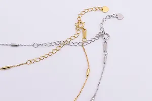 Macro shot of S925 sterling silver chain with cylindrical beads and hallmark tag
