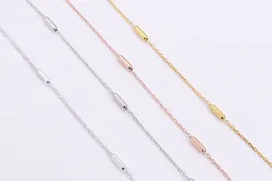 Detail of S925 sterling silver cylinder bead cross chains in silver, gold and rose gold