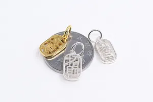 Macro detail of S925 silver prosperity charms with hollowed Chinese characters