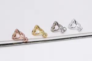 Detailed macro of S925 sterling silver filigree claps in four metallic color finishes