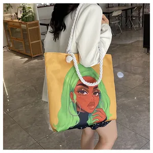 Detail of a large yellow canvas tote bag featuring a green hair artistic girl print