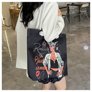 Detail of canvas tote bag with thick rope handles and Rockin' The Black Woman print
