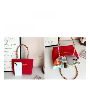 Detail view of the red canvas handbag showing spacious interior for daily essentials