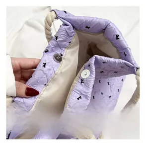 Detail of silver magnetic closure and thick rope handles on a lilac bow tote bag