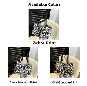 Three animal print tote bags in zebra and leopard patterns with black leather straps