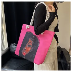Detail of a bright pink canvas tote bag with bold black woman illustration and white rope straps