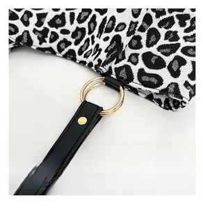Detail of the high-quality gold hardware and leopard print canvas on the tote bag