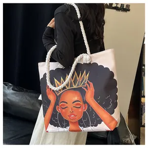 Detail of printed canvas tote bag featuring an African woman portrait and rope handles
