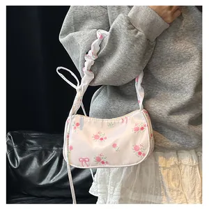 Detailed shot of floral canvas shoulder bag with pink roses and ruffled cloud handle