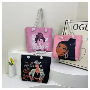 Detailed shot of printed canvas tote bags with thick cotton rope handles on white display