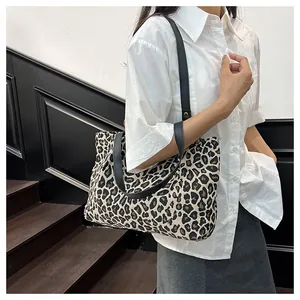 Detail of fashion zebra print canvas tote bag with black straps on shoulder for daily use