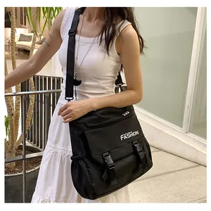 Détail du sac bandoulière utilitaire noir avec imprimé FASHION et boucle réglable