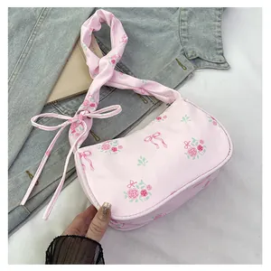 Detail of pink floral canvas bag with delicate rose print and bow knot decoration