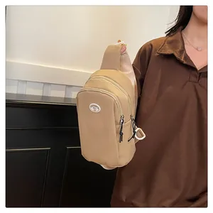 Detail view of water-resistant nylon chest bag with multi-pocket zipper compartments