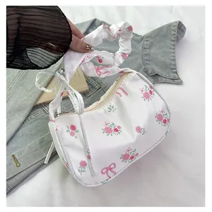 Detail of floral tote bag featuring a scrunchie handle and romantic rose patterns