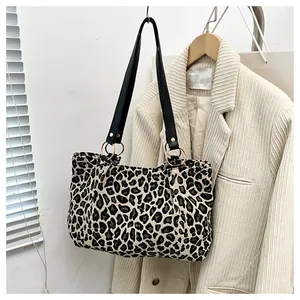 Detail of zebra leopard print tote bag with black strap and golden ring connector