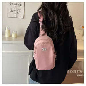 Cute pink nylon crossbody chest bag with minimalist brand logo for casual wear