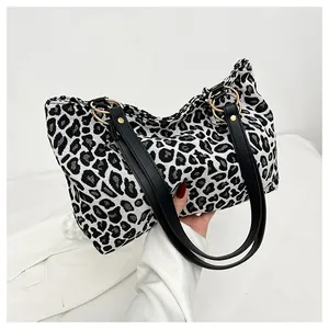 Detail view of the black and white zebra print tote bag with stylish gold metal ring handles