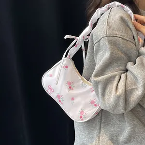 Floral canvas underarm bag with pink roses, bow ties and ruffled drawstring shoulder strap
