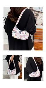 Detailed view of white shoulder bag featuring colorful butterfly patterns and zip closure