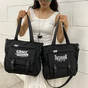 Grands sacs bandoulière en toile noire avec imprimés lettres blanches pour étudiants et jeunes