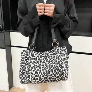 Fashionable zebra print canvas tote bag with black straps and large golden metal rings