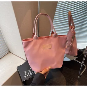 Detailed close-up of pink fashion nylon handbag with FASHION label and zip closure