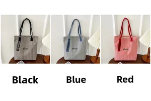 Detailed comparison of striped canvas tote bags in black, blue, and red colors