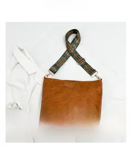 Detail of brown PU leather tote bag with Bohemian style printed wide shoulder strap