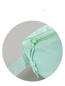 Detailed macro view of mint green canvas fabric texture and matching resin zipper pulls