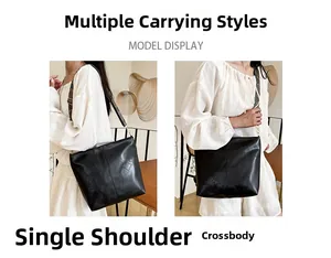 Dual carrying styles of the vintage black leather tote with ethnic patterned wide strap