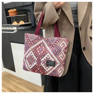 Detail of red geometric ethnic tote bag featuring the Fashion Instinct woven label