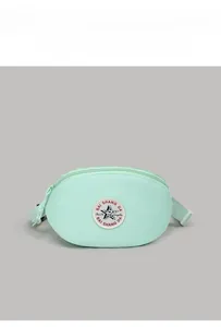 Detail of mint green crossbody bag featuring circular star embroidery and nylon strap