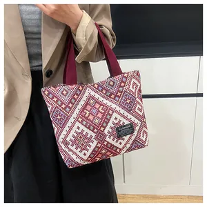 Close-up of ethnic jacquard woven tote bag featuring geometric patterns and fashion label