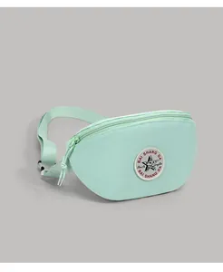 Close-up of mint green nylon waist bag featuring a round logo patch and adjustable strap