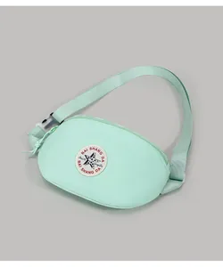 Detail of mint green canvas crossbody bag featuring adjustable strap and star logo
