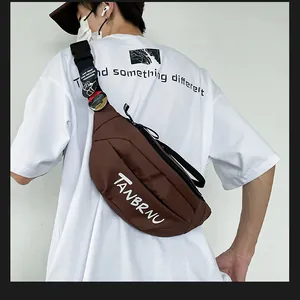 Detailed side view of a brown nylon chest bag with TANBRNU print and adjustable strap