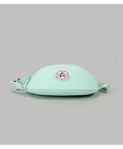 Detailed close-up of mint green canvas waist bag featuring a star patch and strap