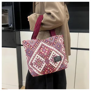Ethnic pattern tote bag detail with red canvas handles and fashion instinct woven label